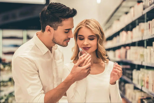 man and woman smelling a nice unisex perfume that they can share