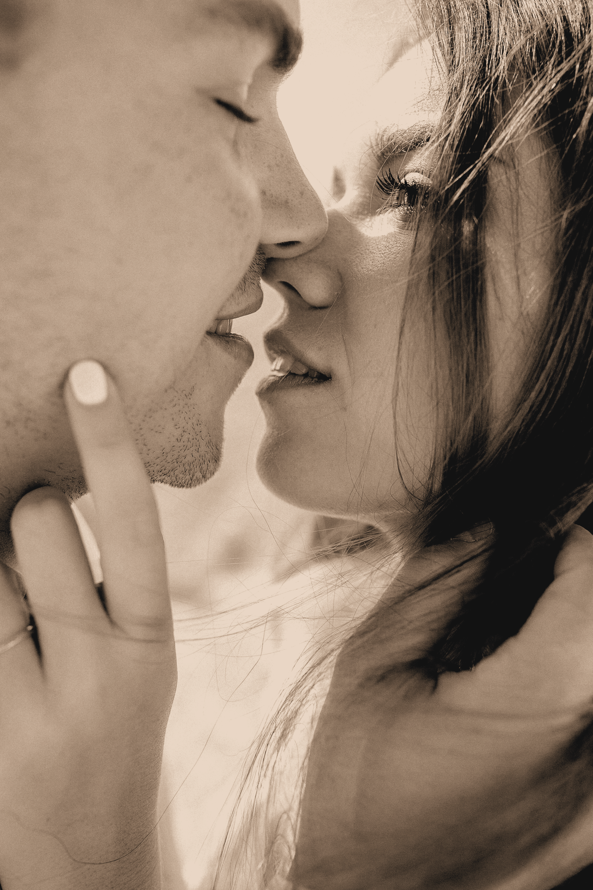 Sepia-toned close-up of a couple embracing